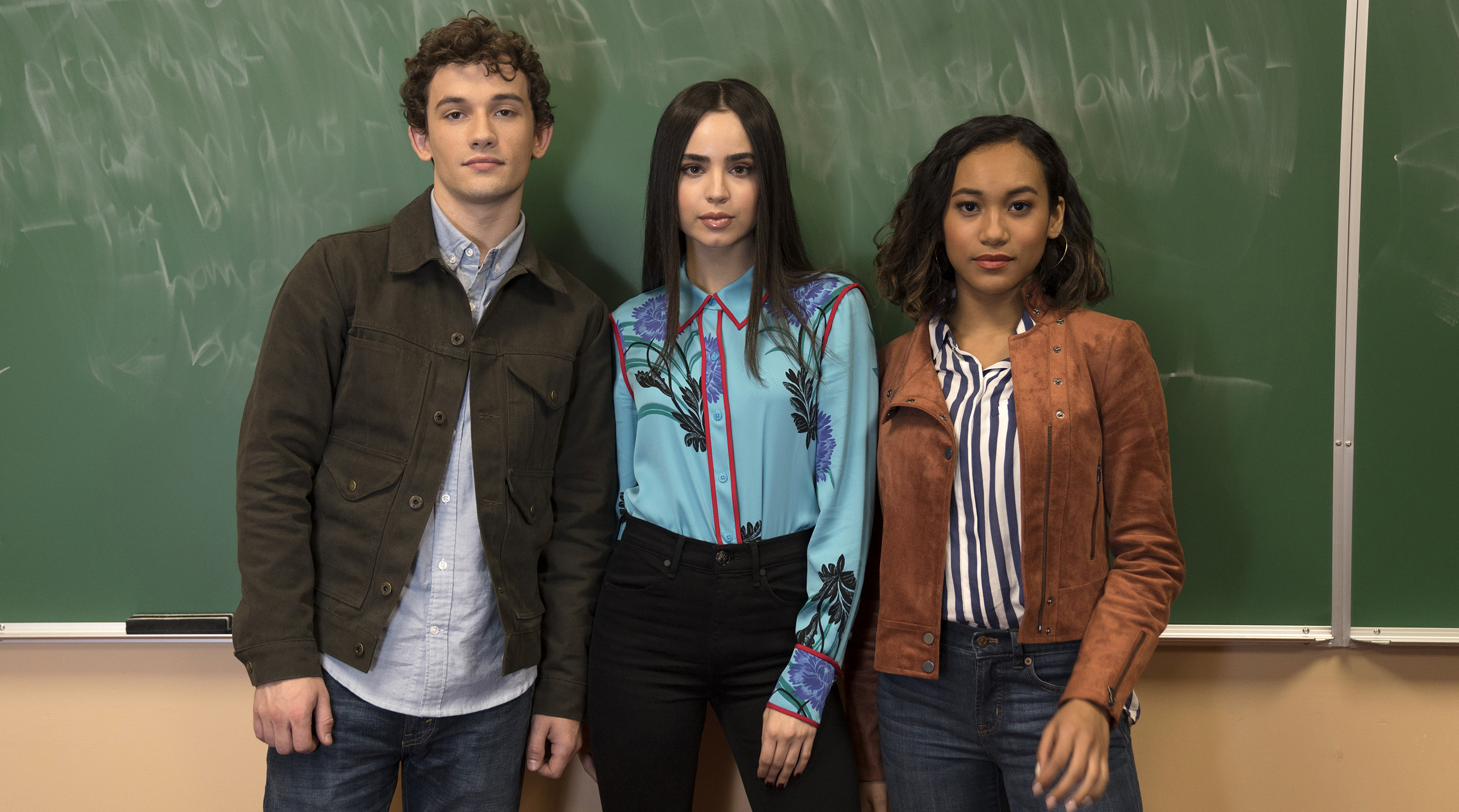 Freeform’s “Pretty Little Liars: The Perfectionists” stars Eli Brown as Dylan, Sofia Carson as Ava, and Sydney Park as Caitlyn. [Freeform/Allyson Riggs]