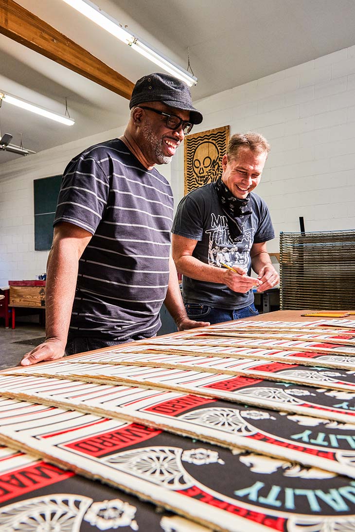 Robert Poulton and Shepard Fairey checking out their print run of 'Push Forward.'