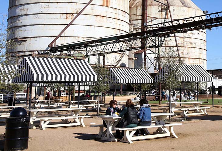 The silos behind some picnic tables at Magnolia Market